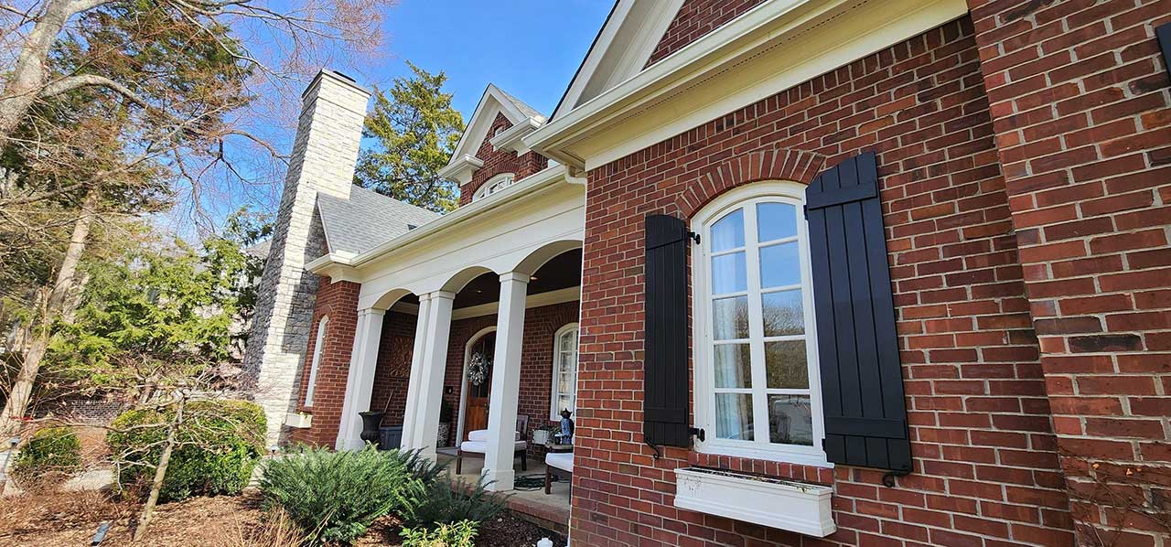 New gutters on a nice-looking brick home.